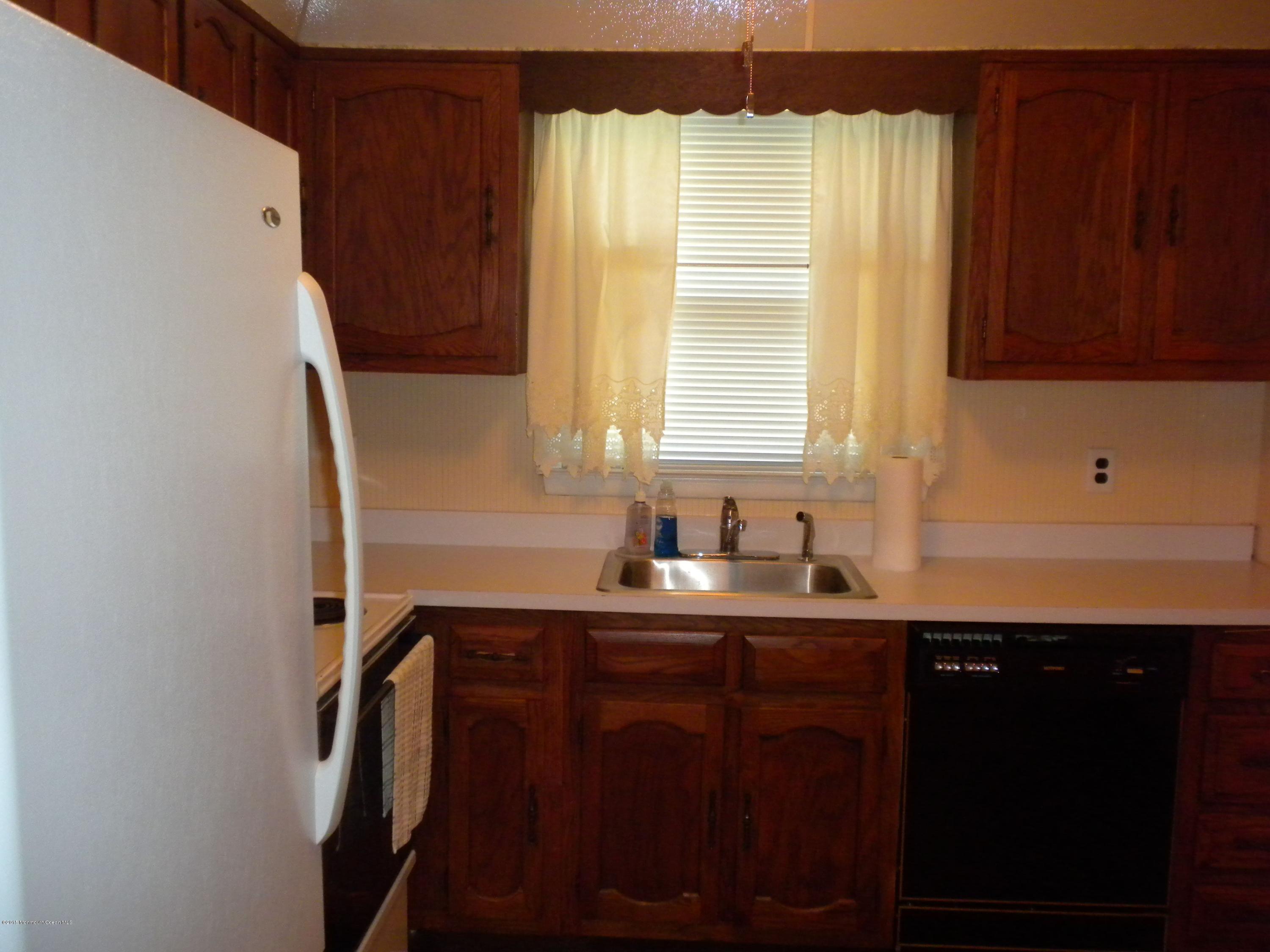 20 D Sycamore Access Road, Unit 4A Manahawkin, NJ 08050 - Photo 18 of 21 a kitchen with a sink a window and cabinets