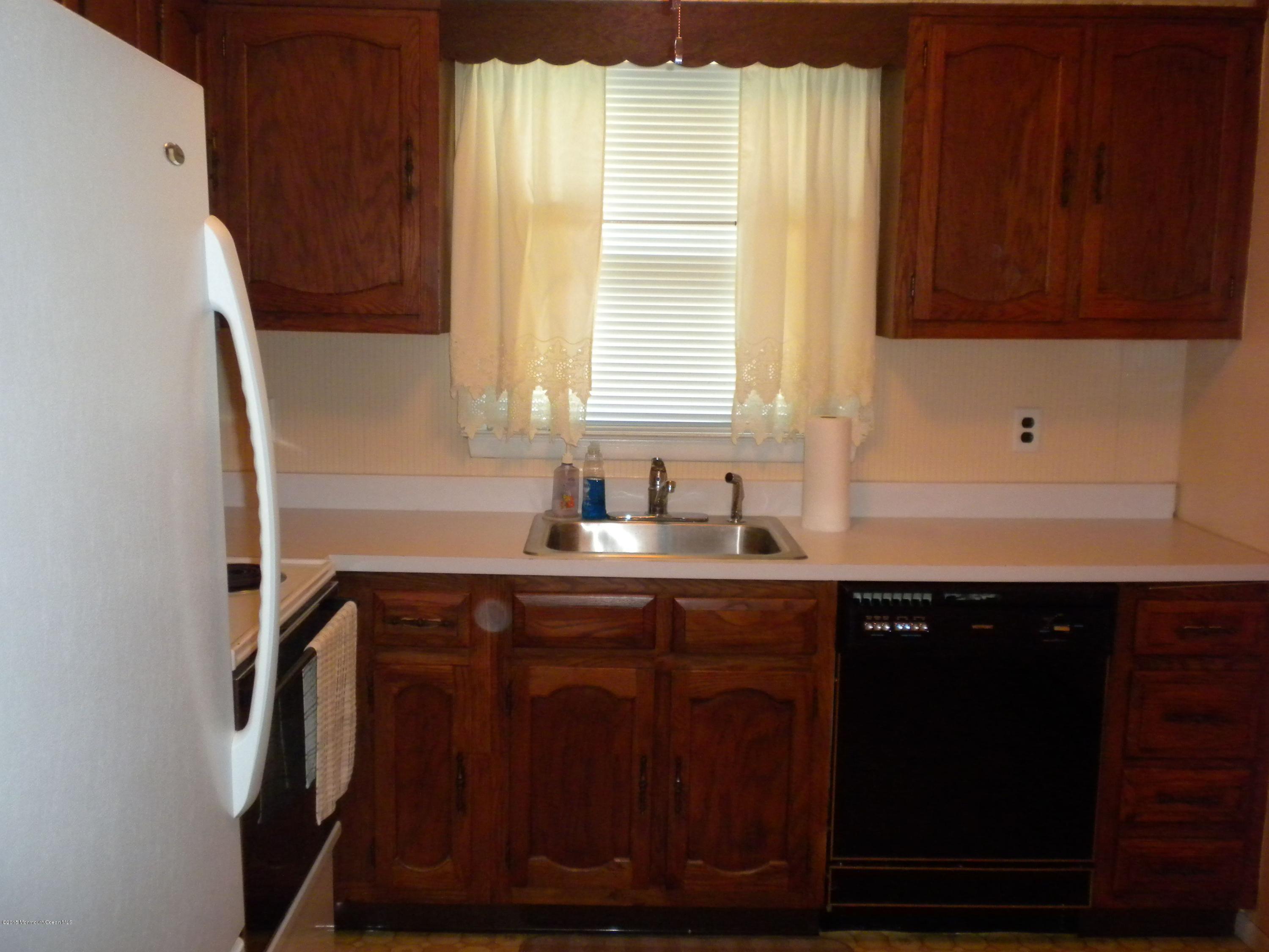 20 D Sycamore Access Road, Unit 4A Manahawkin, NJ 08050 - Photo 19 of 21 a kitchen with a sink a window and cabinets