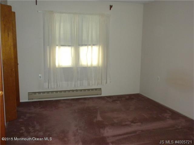 20 D Sycamore Access Road, Unit 4A Manahawkin, NJ 08050 - Photo 3 of 21 an empty room with wooden floor and windows