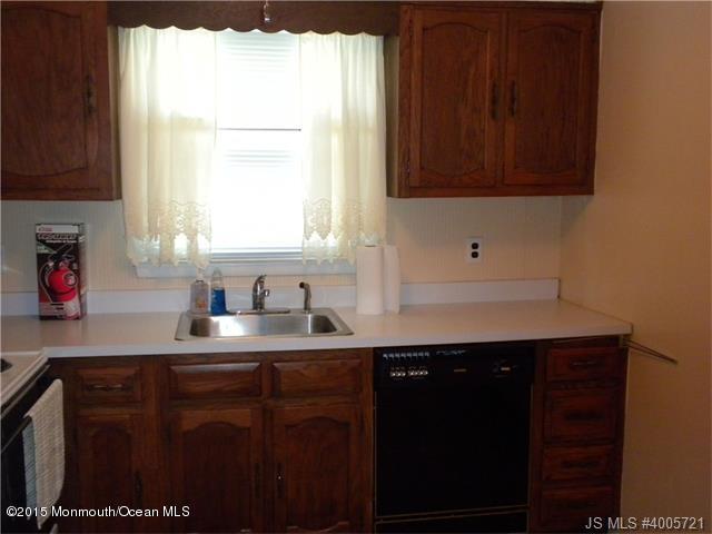 20 D Sycamore Access Road, Unit 4A Manahawkin, NJ 08050 - Photo 6 of 21 a kitchen with a sink a window and cabinets