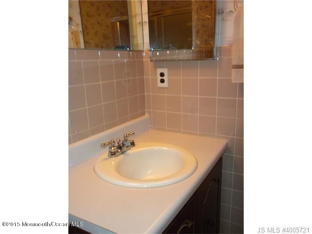 20 D Sycamore Access Road, Unit 4A Manahawkin, NJ 08050 - Photo 8 of 21 a bathroom with a sink and a mirror