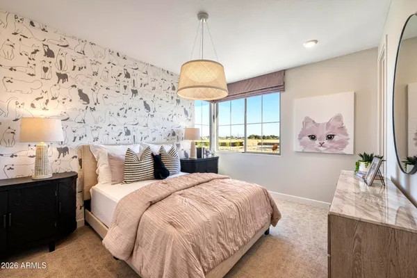 a bed room with a bed and a painting on the wall