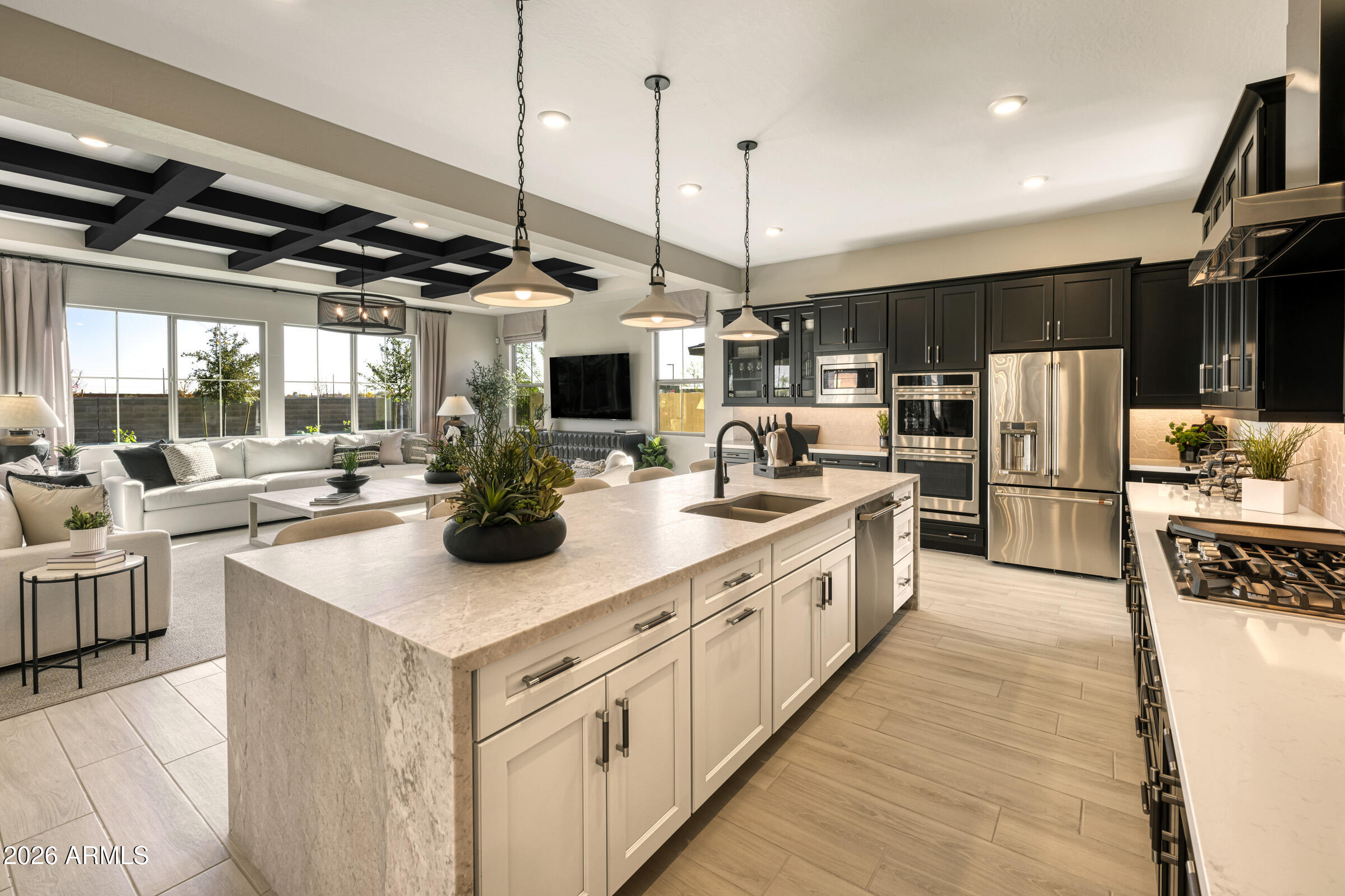5729 South Quartz Street Gilbert, AZ 85298 - Photo 2 of 20 a kitchen with stainless steel appliances kitchen island a large counter top a stove a sink and a refrigerator