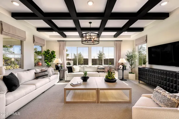 a living room with furniture fireplace and a large window