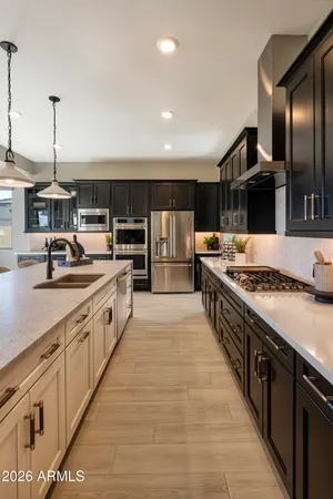 a large kitchen with stainless steel appliances granite countertop a stove a sink and a refrigerator