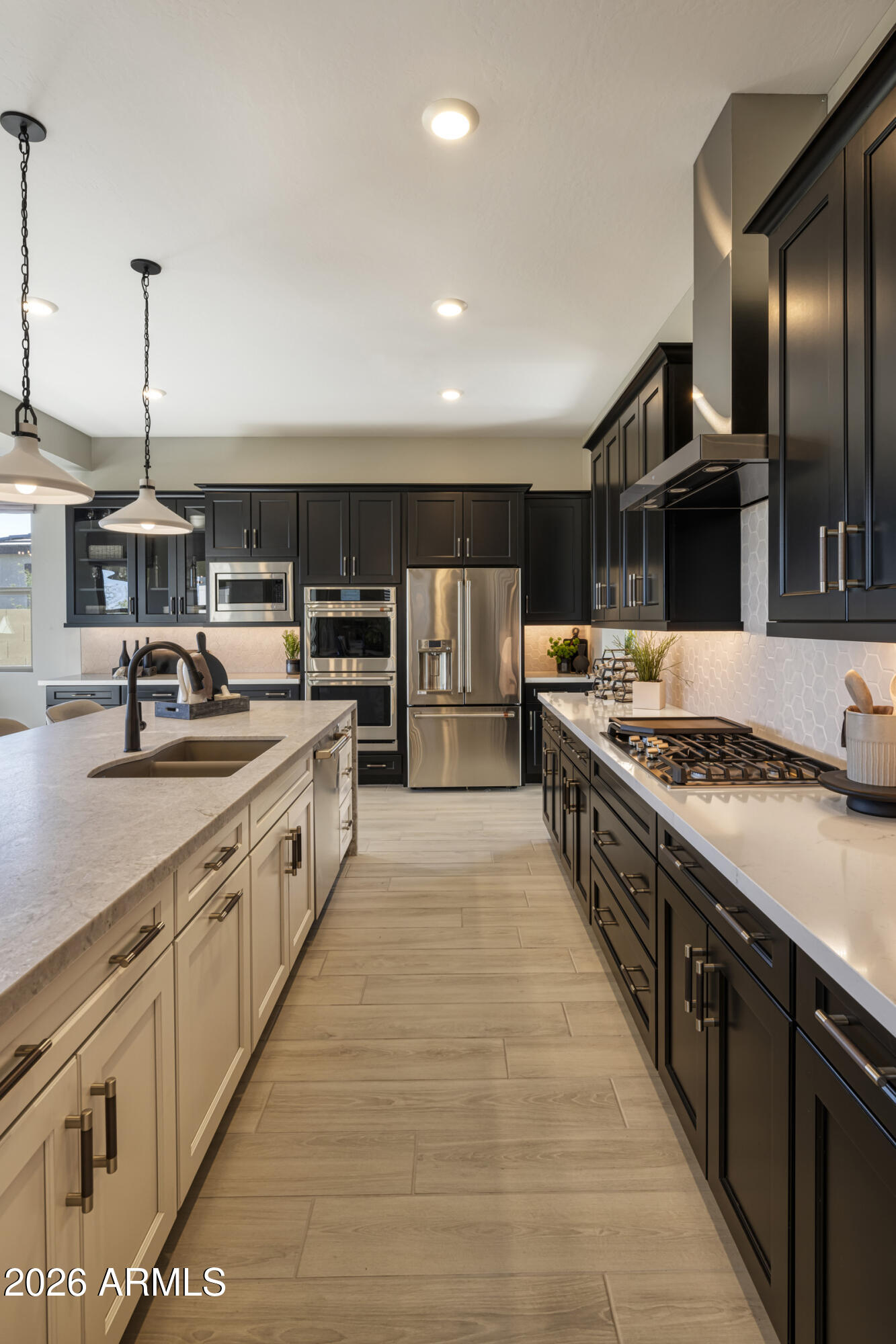 5729 South Quartz Street Gilbert, AZ 85298 - Photo 6 of 20 a large kitchen with stainless steel appliances granite countertop a stove a sink and a refrigerator
