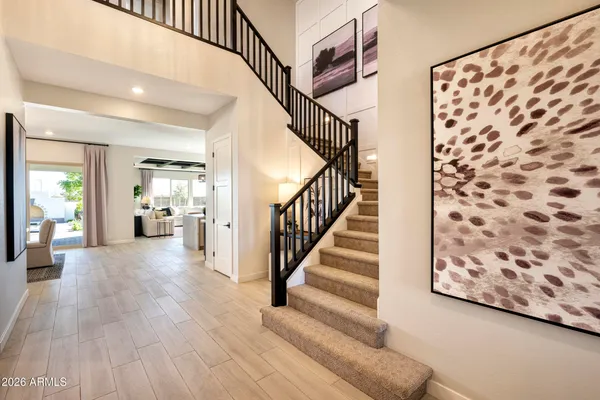 a view of entryway and hall with wooden floor