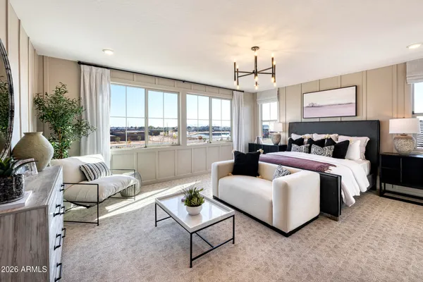 a bedroom with furniture and a large window