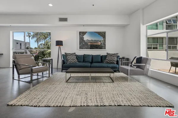 a living room with furniture and a rug