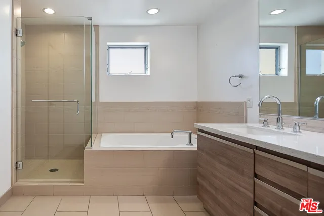 a bathroom with a shower sink and mirror