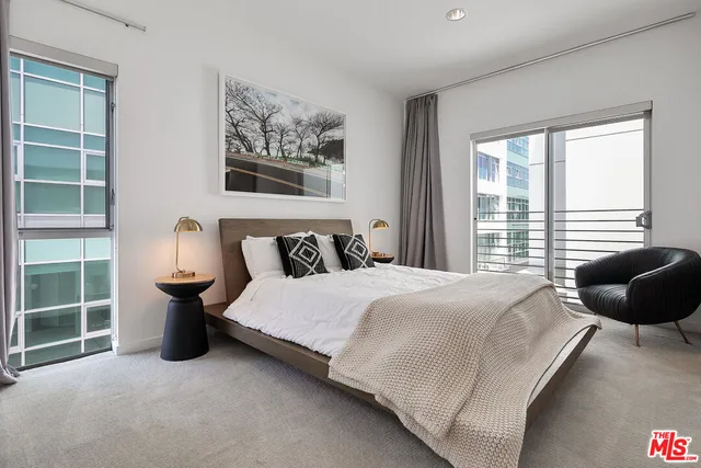 a bedroom with a bed and a large window