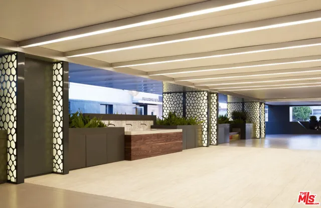 a kitchen with stainless steel appliances kitchen island granite countertop a refrigerator and a sink