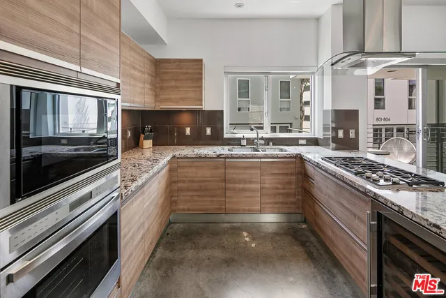 a large kitchen with a stove and a sink