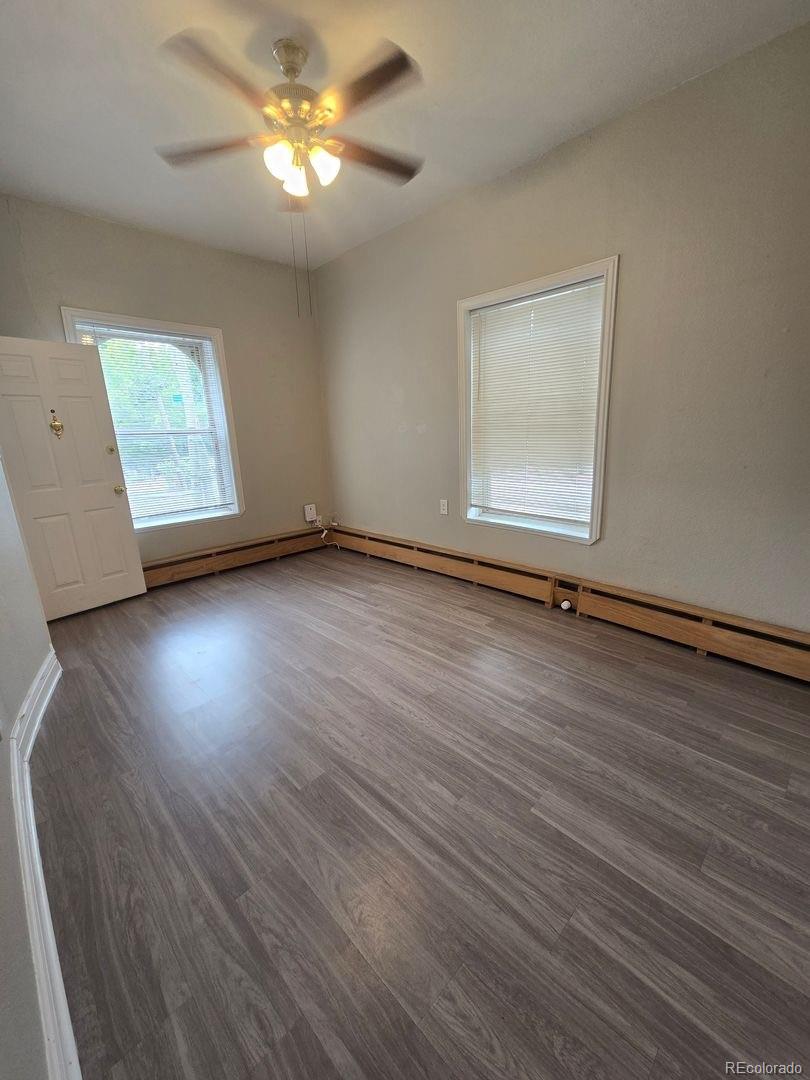 3127 West 28th Avenue, Unit 7 Denver, CO 80211 - Photo 2 of 11 a view of room with window and wooden floor