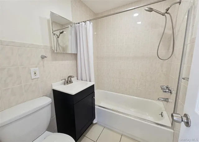 a bathroom with a sink vanity mirror and a bathtub
