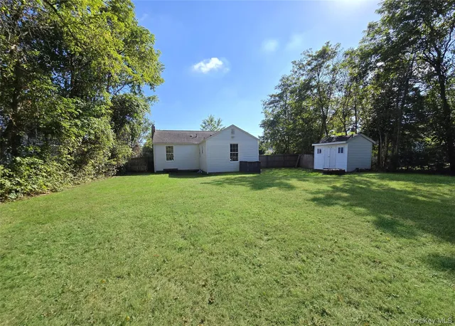 a house view with a sitting space and garden