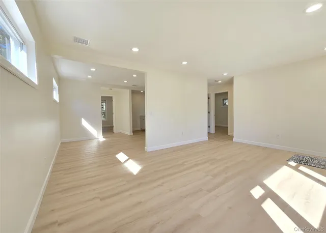 a view of an empty room and a window