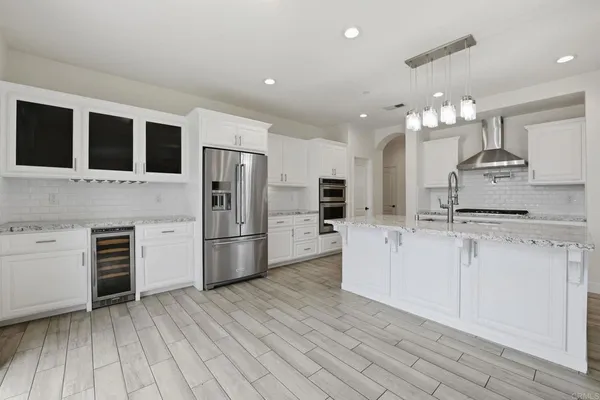 a kitchen with granite countertop cabinets and steel appliances