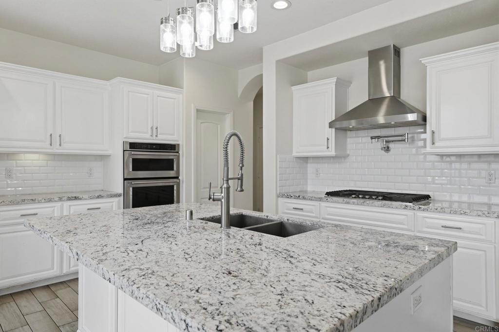 1910 Harbison Canyon Road El Cajon, CA 92019 - Photo 13 of 71 a kitchen with stainless steel appliances granite countertop a sink stove and refrigerator