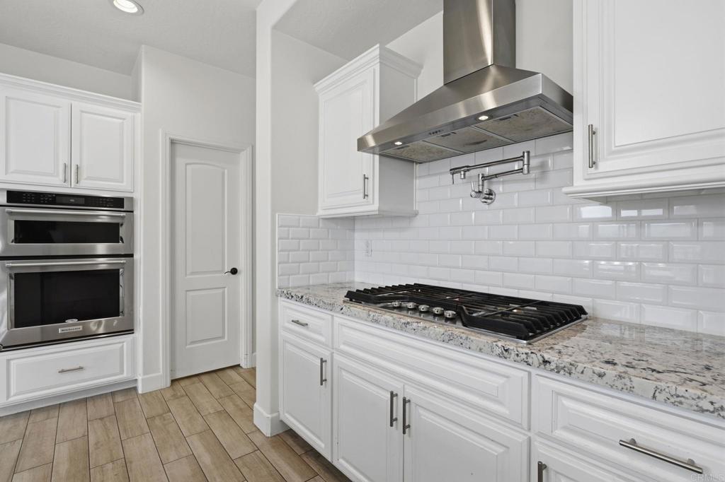 1910 Harbison Canyon Road El Cajon, CA 92019 - Photo 14 of 71 a kitchen with granite countertop cabinets and steel appliances