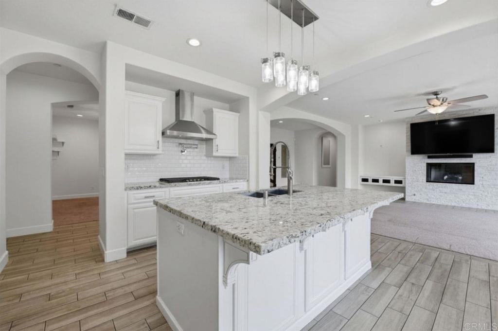 1910 Harbison Canyon Road El Cajon, CA 92019 - Photo 16 of 71 a kitchen with stainless steel appliances granite countertop a kitchen island a stove and a sink