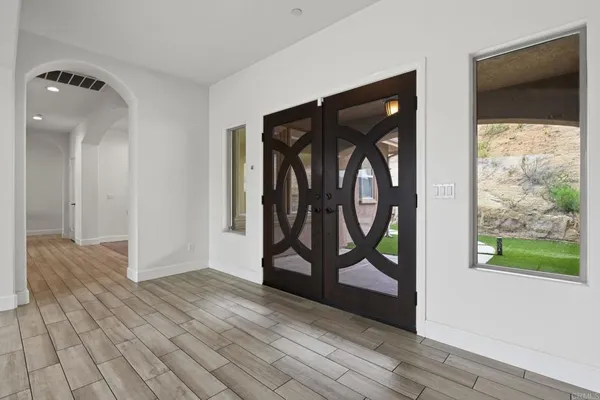 a view of a room with wooden floor and a bathroom