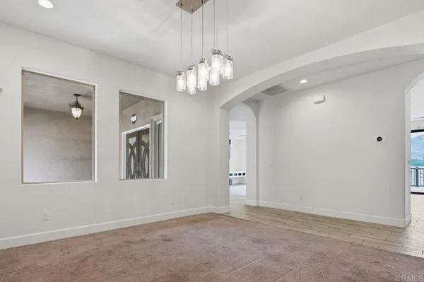 a view of a livingroom with a ceiling fan and window