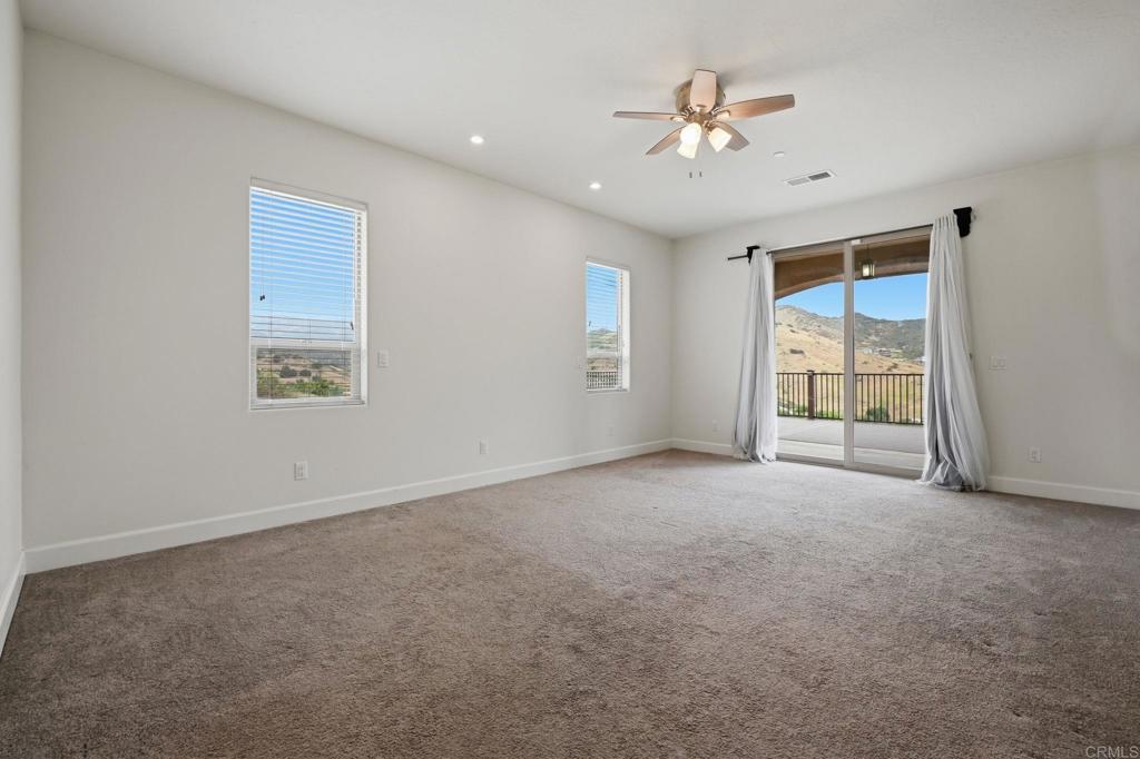 1910 Harbison Canyon Road El Cajon, CA 92019 - Photo 21 of 71 a view of a livingroom with a ceiling fan and window