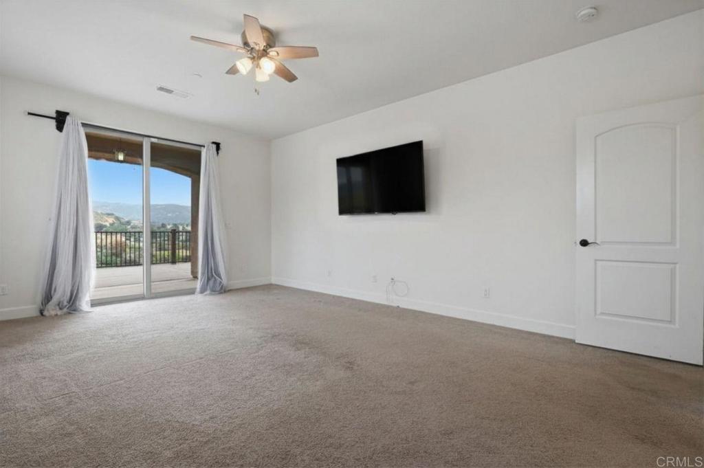 1910 Harbison Canyon Road El Cajon, CA 92019 - Photo 22 of 71 a living room with flat screen tv and a ceiling fan