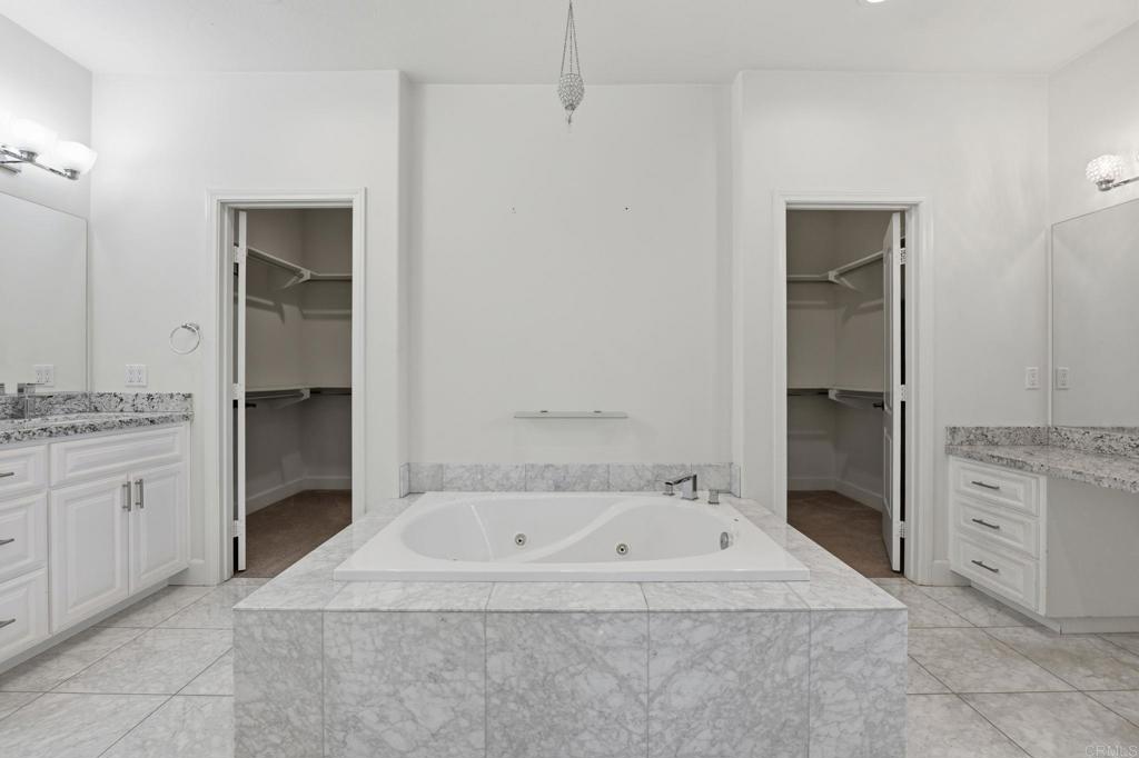 1910 Harbison Canyon Road El Cajon, CA 92019 - Photo 24 of 71 a bathroom with a granite countertop sink and mirror