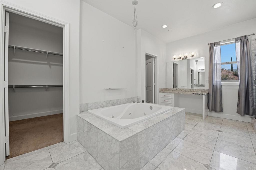 1910 Harbison Canyon Road El Cajon, CA 92019 - Photo 25 of 71 a large spacious bathroom with a tub and a shower