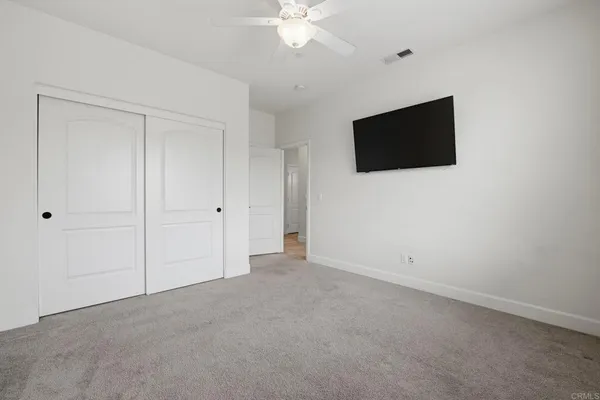 a bathroom with a granite countertop sink and a toilet