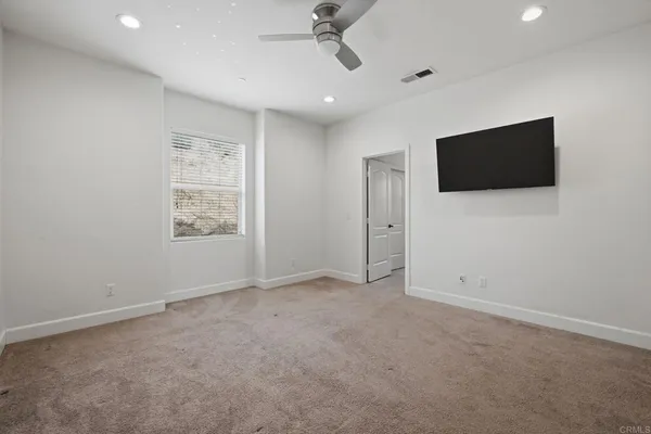 a bathroom with a granite countertop toilet and a sink