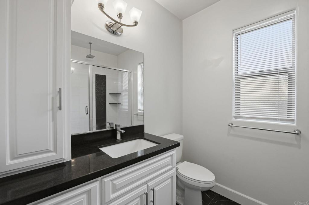 1910 Harbison Canyon Road El Cajon, CA 92019 - Photo 39 of 71 a bathroom with a granite countertop sink and a toilet