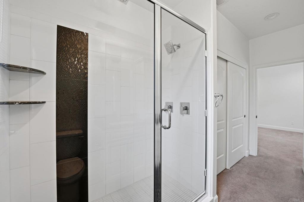1910 Harbison Canyon Road El Cajon, CA 92019 - Photo 40 of 71 a bathroom with a shower and a glass door