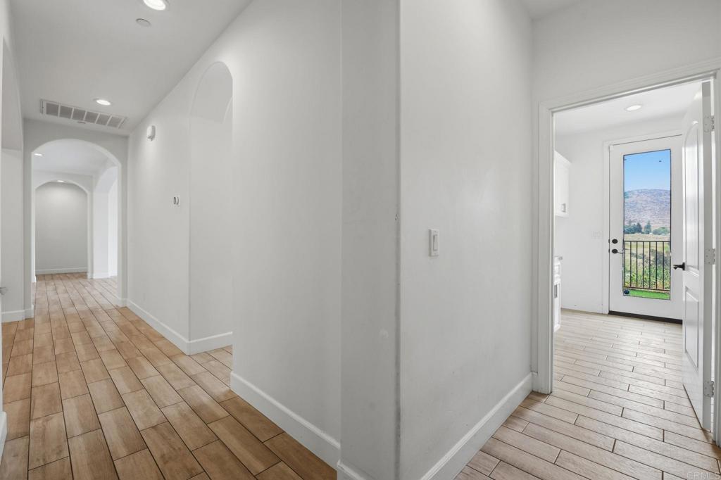 1910 Harbison Canyon Road El Cajon, CA 92019 - Photo 41 of 71 a view of a hallway with wooden floor