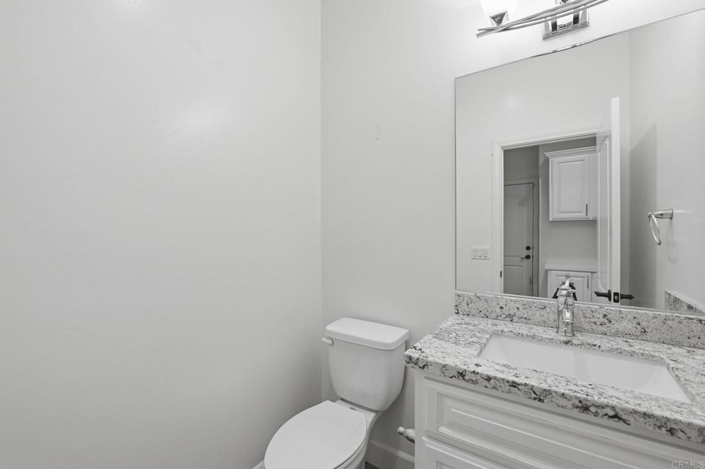 1910 Harbison Canyon Road El Cajon, CA 92019 - Photo 44 of 71 a bathroom with a granite countertop toilet and a sink