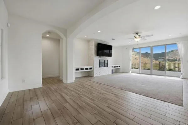 a view of a livingroom with an empty space and a flat screen tv