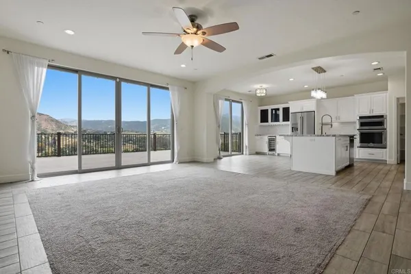 a kitchen with stainless steel appliances kitchen island granite countertop a refrigerator and a stove top oven