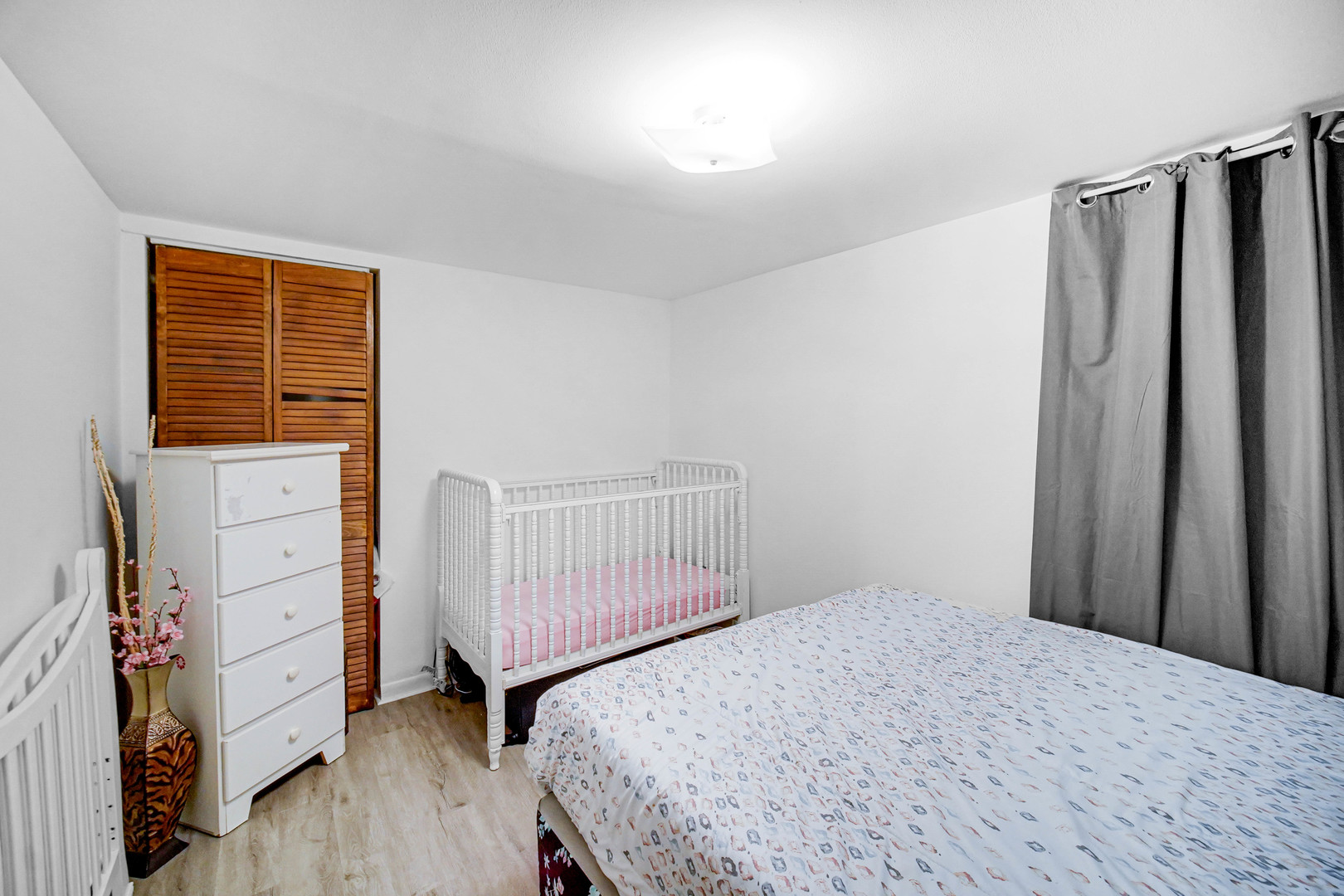 Undisclosed Address Chicago, IL 60641 - Photo 15 of 18 a bedroom with a bed and wooden floor