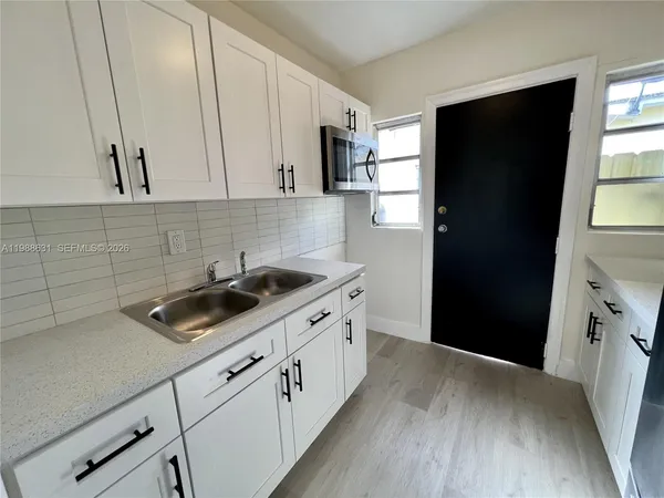 a kitchen with a sink stove and refrigerator