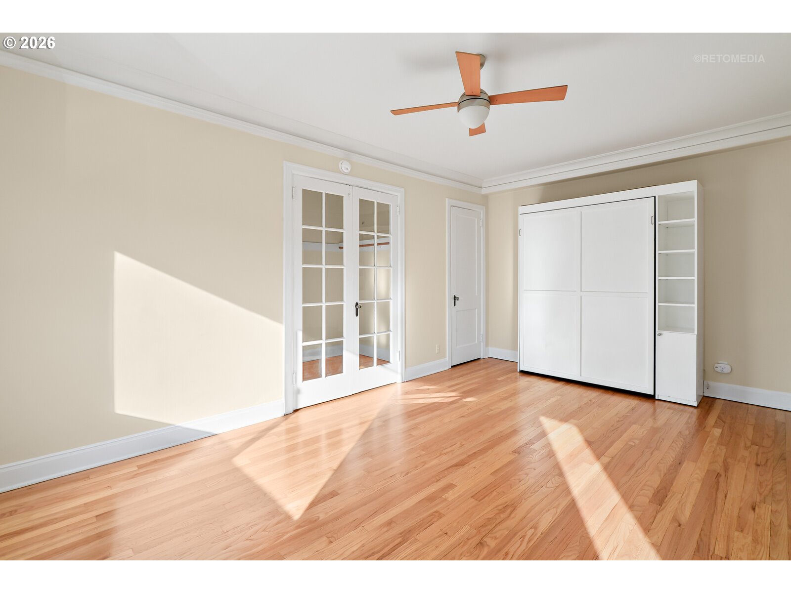 709 Southwest 16th Avenue, Unit 308 Portland, OR 97205 - Photo 11 of 22 an empty room with wooden floor and ceiling fan