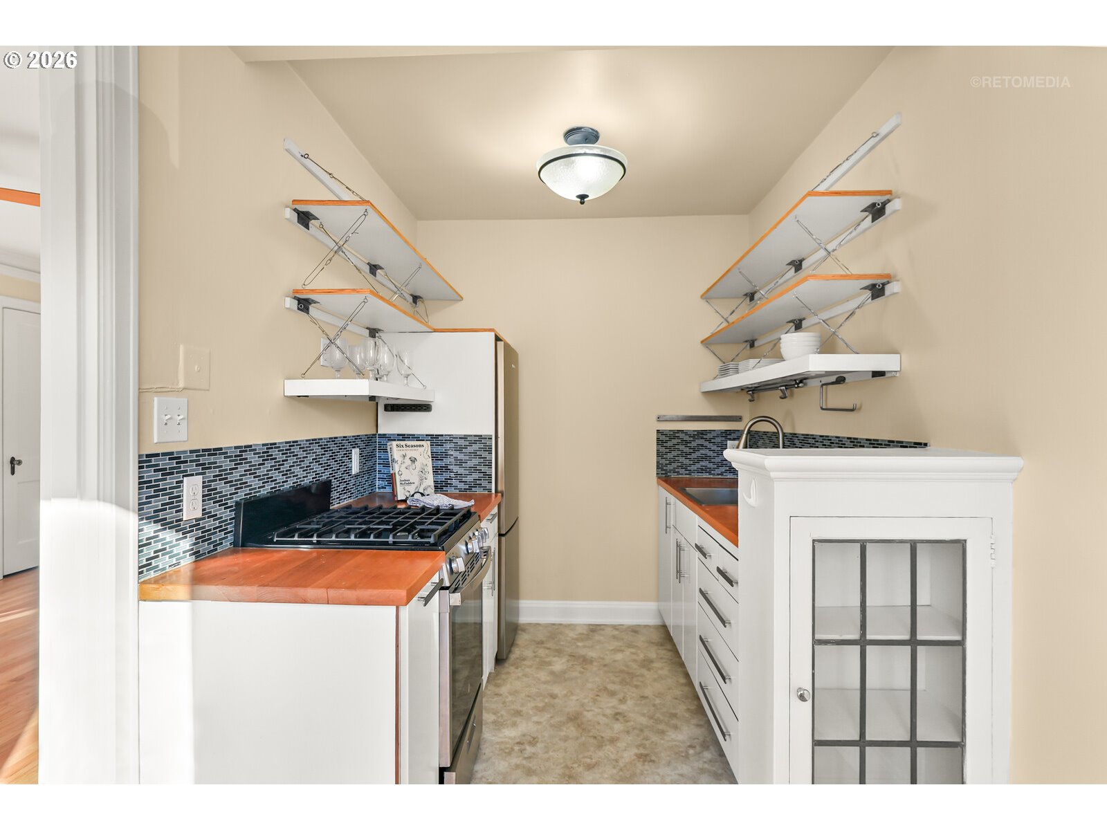 709 Southwest 16th Avenue, Unit 308 Portland, OR 97205 - Photo 13 of 22 a kitchen with a stove and a microwave