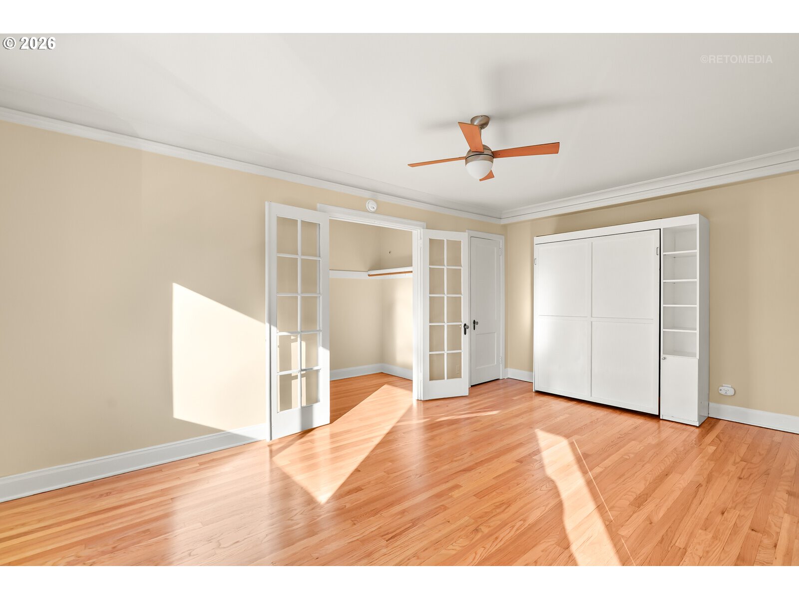 709 Southwest 16th Avenue, Unit 308 Portland, OR 97205 - Photo 10 of 22 a view of an empty room with wooden floor and a ceiling fan