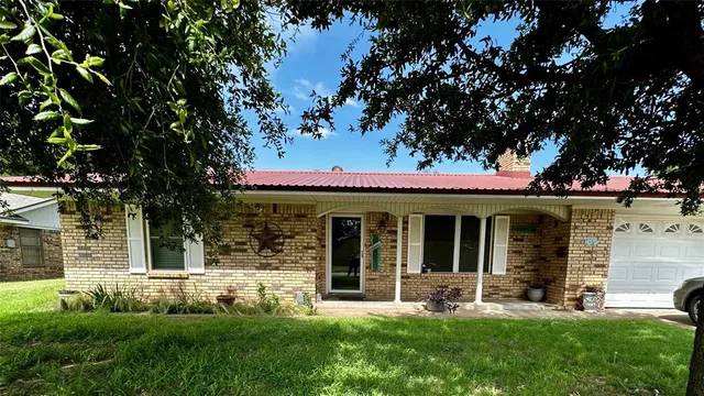 a view of a house with a yard porch and sitting area