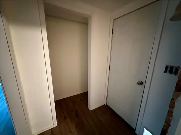 an empty room with wooden floor