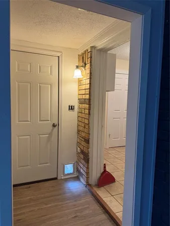 a view of a hallway with wooden floor and closet area