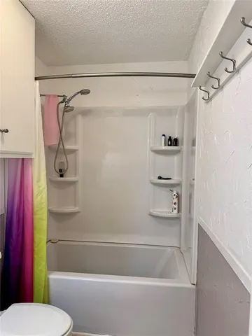 a bathroom with a shower and toilet