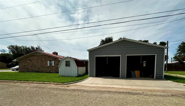 a front view of a house with a garden and garage