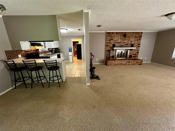 a view of a livingroom with furniture and a window